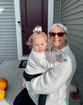 Mom and daughter are wearing matching mommy and me head wraps from By Bella Boutique.